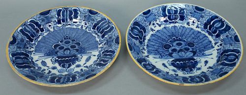 Pair of Delft tin glazed deep chargers, each with yellow rims, probably 18th century. 
(glaze chips and minor rim chips) 
dia