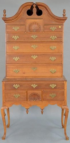 Queen Anne cherry high chest of drawers in two parts, upper portion having full bonnet top with swan's neck and three finials