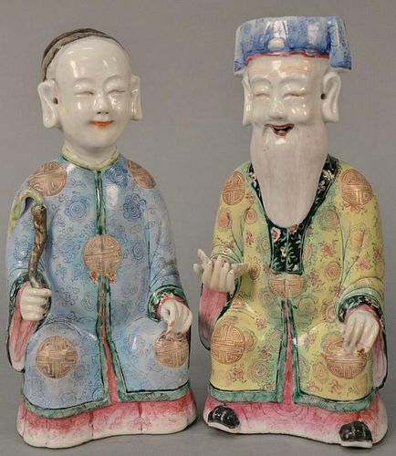 Pair of Chinese porcelain figures, each in robes, labeled under Earle D. Vandekar. 
height 10 inches