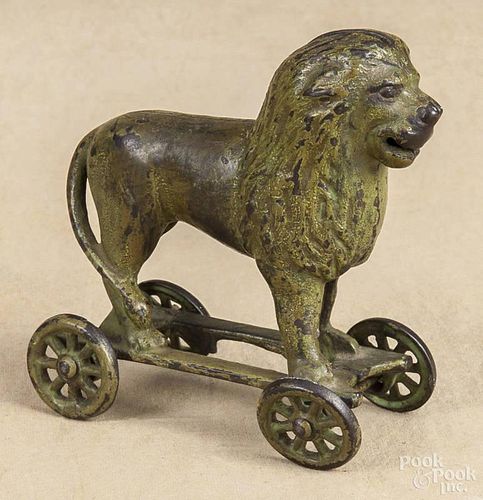 Cast iron Lion on Wheels penny bank, manufactured by A. C. Williams.