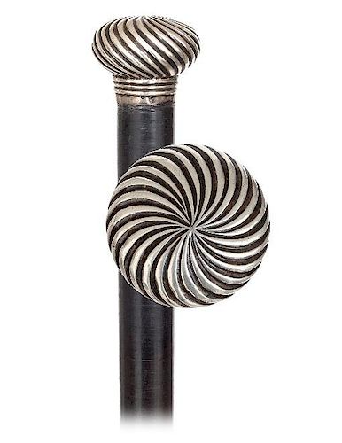 117. Decorative Silver and Defense Day Cane -Ca. 1880 -Featuring a round and flattened silver knob hand chased with a twirlin