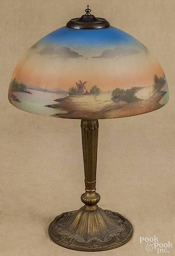 Gilt cast iron table lamp, early 20th c., with a reverse painted shade, 21'' h., 14'' dia.