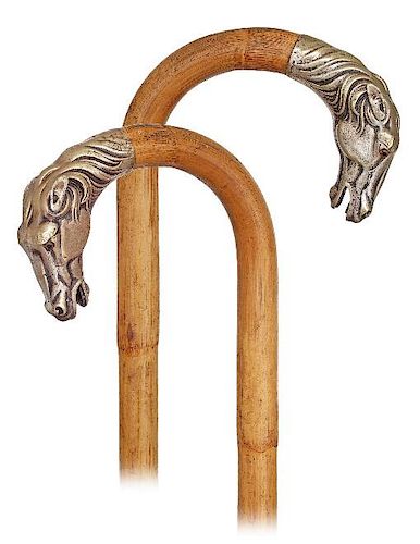 130. Horse Cane -Ca. 1910 -Sturdy single stepped malacca cane with a crook handle embellished by a white metal horse head sta