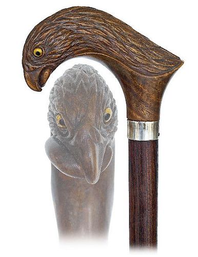 133. Figural Day Cane -Ca. 1900 -Large and curving Lignum Vitae handle carved to depict a predatory bird’s head with a snak