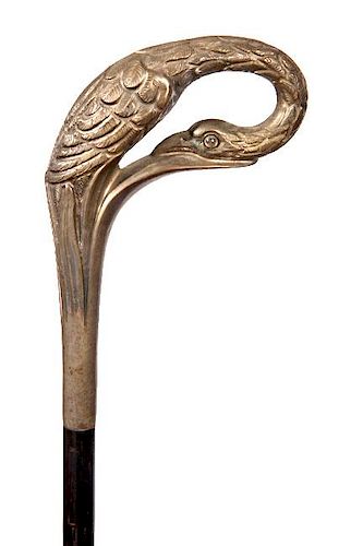 148. Egret Dress Cane-  Ca. 1890- A cast metal dress handle with one glass eye, ebony shaft and a horn ferrule. H.- 5 ½” x