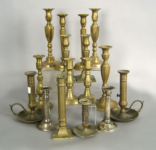 Fourteen brass candlesticks, together with a pair