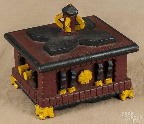 Painted pine trick box, early 20th c., in a red, black, and yellow surface, 8'' h., 8 1/4'' w.