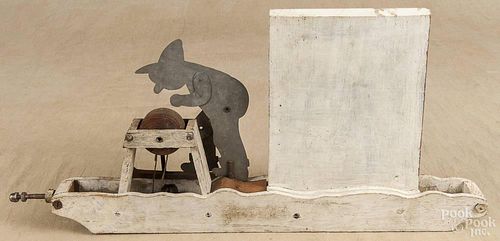 Painted pine and tin whirligig, early 20th c., of a man at a grinding wheel, 22 3/4'' l.