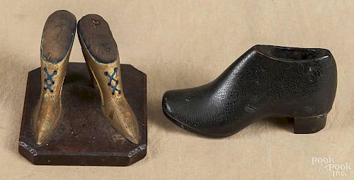 Carved and painted pair of shoe pincushions, late 19th c., 3'' h. and 4'' w.