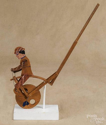 Painted pine cutout bicycle rider push toy, 20th c., 22 1/2'' l.