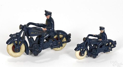 Two Champion cast iron police motorcycles, 7'' l. and 5'' l.