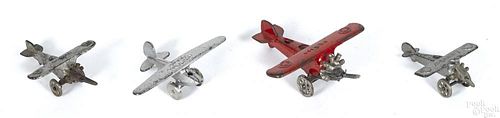 Four small cast iron airplanes, to include Lucky Boy, Lucky Boy Glider, UX99, and UX166