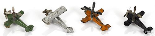 Four small cast iron airplanes, to include Lucky Boy and three Hubley Giro Plane