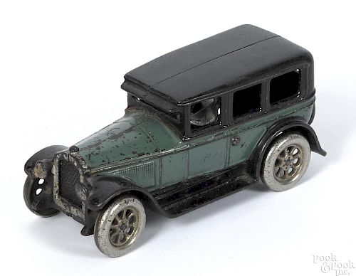 Arcade cast iron Buick sedan with a nickel-plated driver and spoked wheels, 8 1/4'' l.