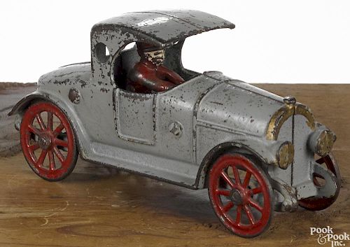Hubley cast iron ''port hole coupe'' roadster with a painted driver, 7'' l.