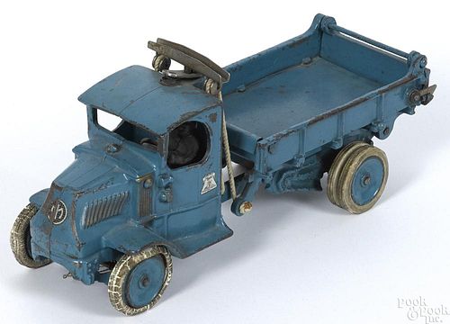 Arcade cast iron Mack T-bar dump truck with a nickel-plated driver and rubber tired disc wheels