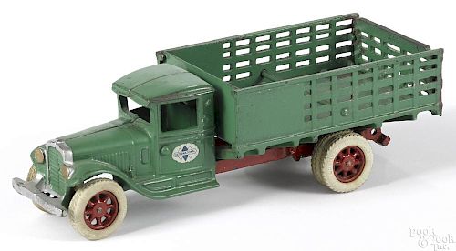 Arcade cast iron International low side stake truck with rubber tired spoke wheels, 12'' l.