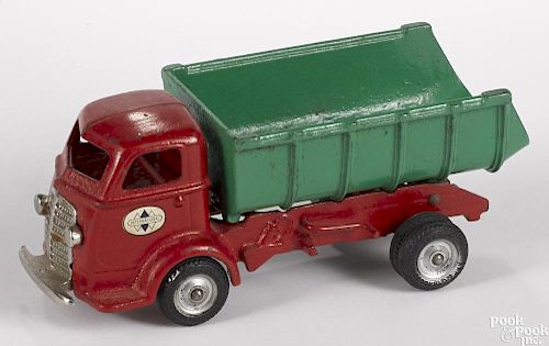 Arcade cast iron International cab over engine dump truck with a nickel-plated grill and bumper