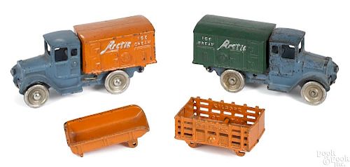 Two Kilgore cast iron Arctic Ice Cream delivery trucks, one with the spare dump bed