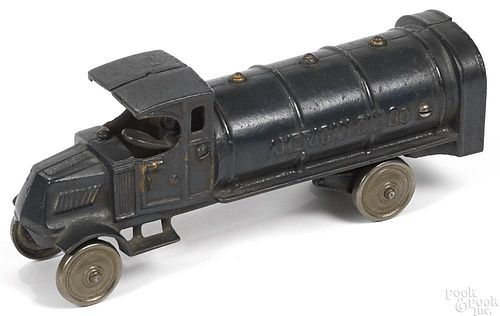 Dent cast iron American Oil Co. tanker truck with a painted driver and nickel-plated disc wheels