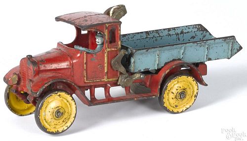 Dent cast iron dump truck with a painted driver, 11'' l. Provenance: Donald Kaufman collection