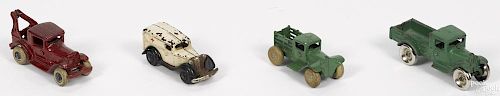 Four small cast iron vehicles, to include a wrecker, inscribed Weller Bros - wrecker services