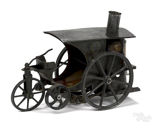 Scarce Schoenner tin live steam trike, hand painted, with cast iron wheels, 6'' h., 8'' w.