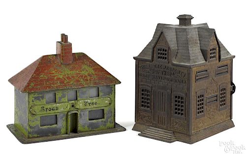 Two large cast iron building still banks, to include a Broad Tree cottage, 8 1/2'' h.
