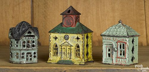 Three cast iron building still banks, to include a Kyser & Rex with a clock tower, 4 3/4'' h.