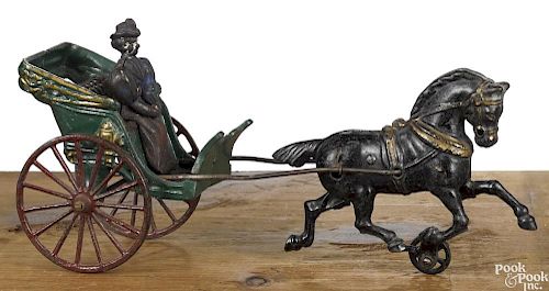 Hubley cast iron horse drawn open cart with a woman driver, 12'' l.