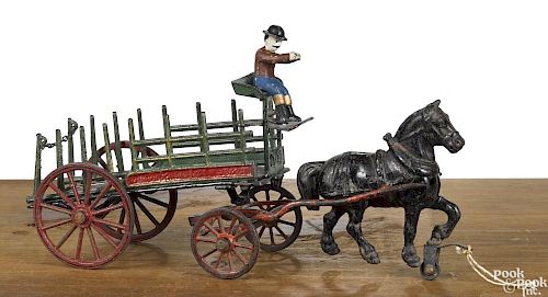 Pratt & Letchworth cast iron one-horse dray wagon with stake sides and a painted driver