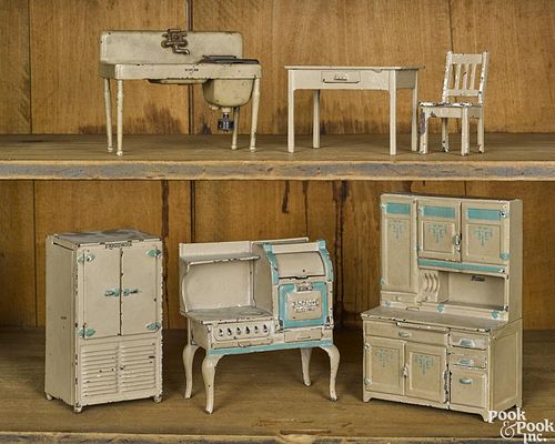 Six-piece Arcade cast iron doll house kitchen, to include a cupboard, a stove, a sink, etc.