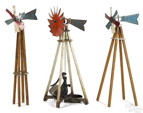 Three Arcade cast iron and wood toy windmills, one with an attached water pitcher pump