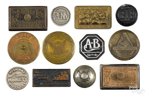 Twelve cast iron advertising paperweights, to include Pictet Ice Refrigerating Machines