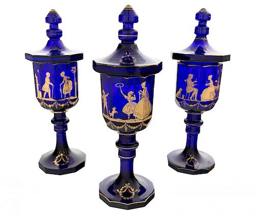 A SET OF THREE DECORATED COVERED COBALT GLASS GOBLETS, PROBABLY IMPERIAL GLASS FACTORY, ST. PETERSBURG, CIRCA 1800