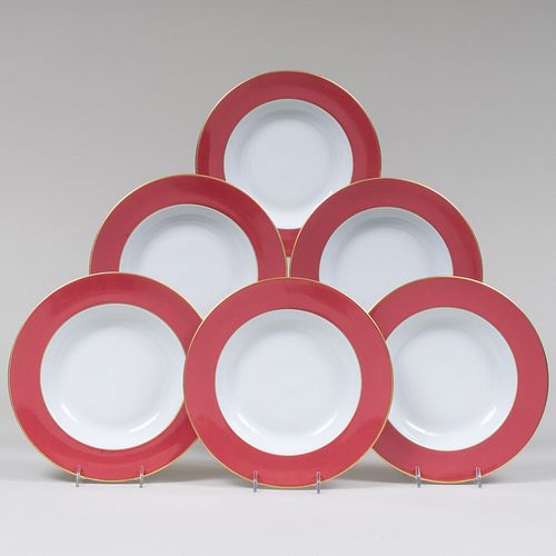 Set of Twenty-Four Limoges Claret Ground Porcelain Soup Plates