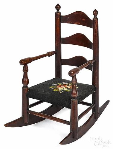 Child's ladderback rocking chair, 19th c., with a needlepoint seat, 23 1/2'' h.