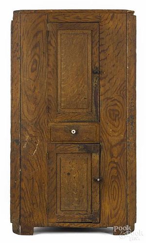 Pennsylvania painted pine corner cupboard, 19th c., retaining its original yellow grained surface