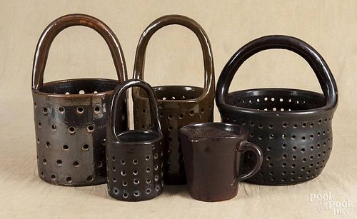 Four stoneware cheese strainers, 19th c., tallest - 15 1/2'', together with a stoneware pitcher