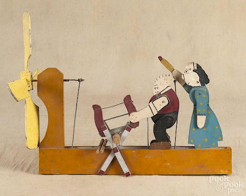 Painted pine cutout whirligig of Maggie & Jiggs sawing wood, 20th c., 22 1/2'' l.