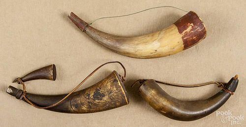 Four powder horns, one with a geometric and hatch carving, 19th c., 11'' l.