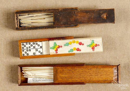 Group of bone splicing tools in a slide lid box, together with a set of miniature bone dominoes.