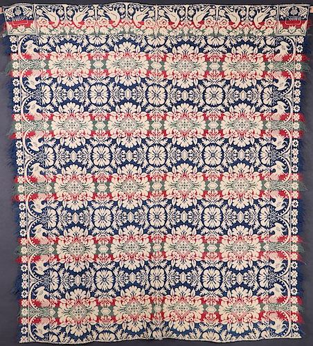 A BLUE, RED, GREEN AND IVORY COVERLET, MID 19TH C