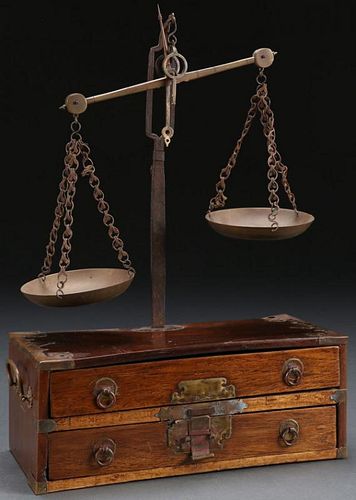 A BRONZE SCALE MOUNTED ON A WOOD BOX