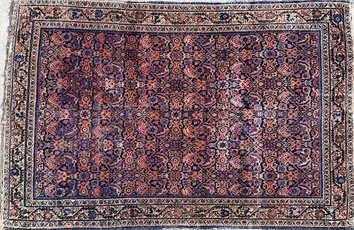 A PERSIAN RUG WITH OVERALL HERATI PATTERN