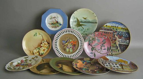 Nine painted porcelain plates, together with 2 tin