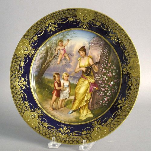 Painted porcelain plate with a maiden and 3 childr