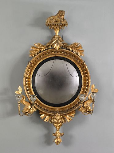 Carved and gilded convex mirror, ca. 1800, with li