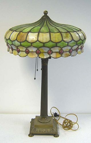 Brass lamp with green and yellow leaded glass shad