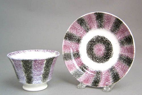 Purple and black rainbow spatter cup and saucer.
